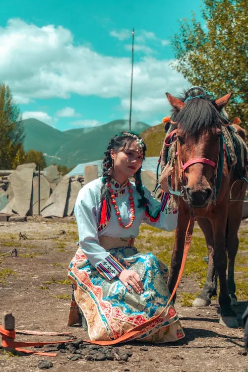 Chinese girl sitting next to horse